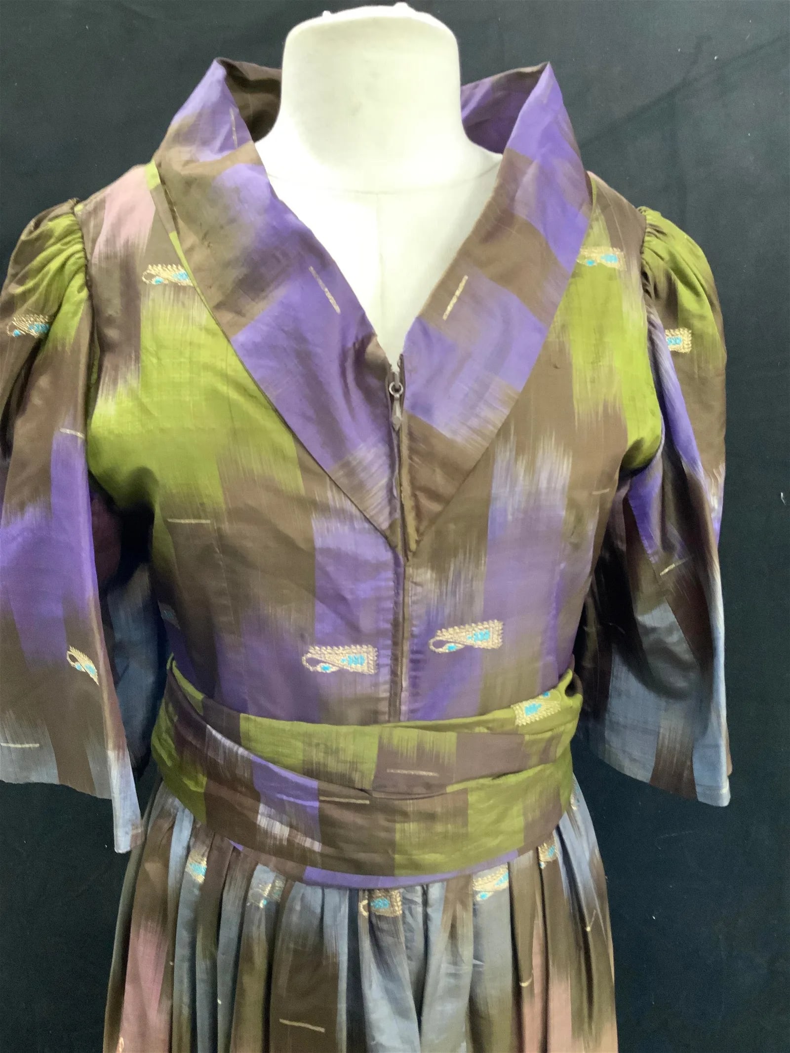 Handmade 50s Dress with Belt: silk fabric with gold & aqua embroidered design. Dress has a gradual color change of green-brown to purple-light blue, & pink. Pleated waist with wide wrap belt. Zippered front with retro style V neck