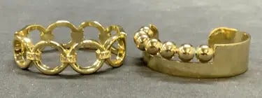 Gold Tone Beaded and Crystal Cuff Bracelets: Lot of 2 gold tone cuff bracelets. 1 hinged bracelet with open circle and crystal decoration. Measures approx. 2.25 inches wide. 1 beaded decorated cuff bracelet. Measures approx. 2.25 inches wide. Bo