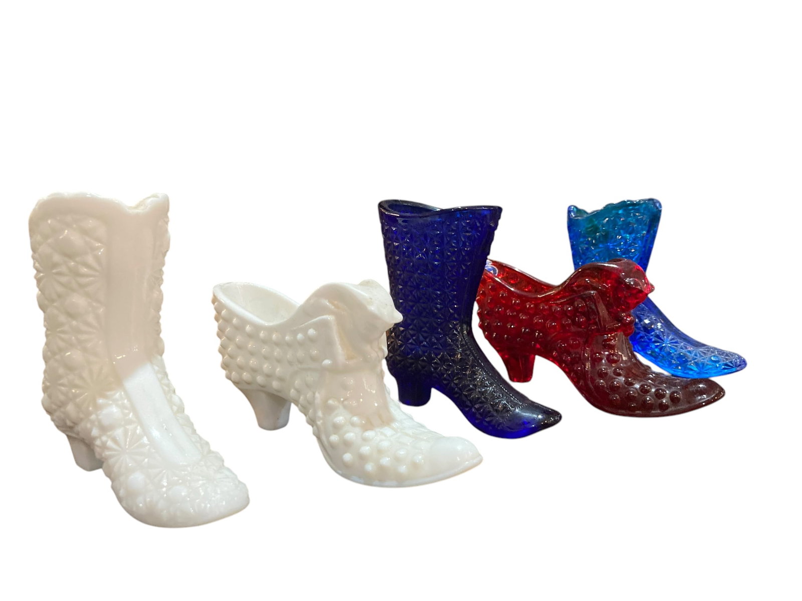 5 PC Fenton Glass Hobnail Shoe Lot: 5 pc lot includes one milk glass boot, one milk glass hobnail shoe, a blue glass boot, a red hobnail shoe, and another lighter blue boot. All are made by Fenton, some have original stickers. In great