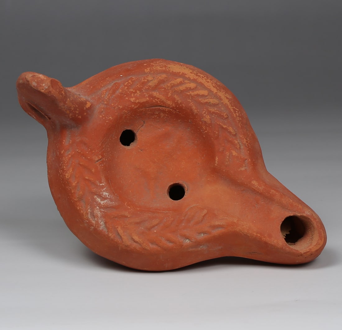 Late Roman oil lamp depicting an animal, Type Atlante VI: ITEM: Oil lamp depicting an animal, Type Atlante VI MATERIAL: Pottery CULTURE: Roman PERIOD: 4th - 5th Century A.D DIMENSIONS: 55 mm x 82 mm x 130 mm CONDITION: Good condition PROVENANCE: