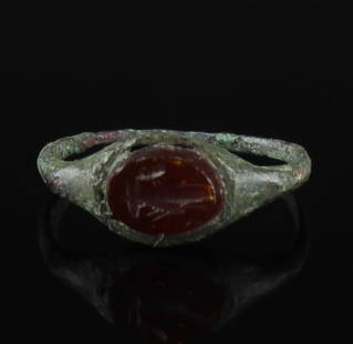 Roman ring with carnelian: ITEM: Ring with carnelian MATERIAL: Bronze CULTURE: Roman PERIOD: 2nd - 3rd Century A.D DIMENSIONS: 19 mm x 18 mm CONDITION: Good condition PROVENANCE: Ex German private collection, D.T., Southern