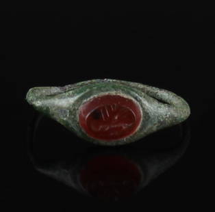 Roman ring with carnelian: ITEM: Ring with carnelian MATERIAL: Bronze CULTURE: Roman PERIOD: 2nd - 3rd Century A.D DIMENSIONS: 16 mm x 16 mm CONDITION: Good condition PROVENANCE: Ex German private collection, D.T., Southern