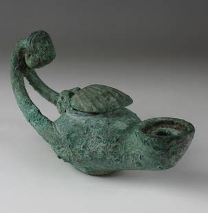 Byzantine oil lamp with male mask terminal: ITEM: Oil lamp with male mask terminal MATERIAL: Bronze CULTURE: Byzantine PERIOD: 5th - 6th Century A.D DIMENSIONS: 80 mm x 60 mm x 140 mm CONDITION: Good condition PROVENANCE: Ex Emeritus