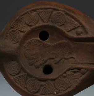 Late Roman / Christian oil lamp depicting a lion, Type Bussière E IX 31 - Atlante X A1 a: ITEM: Oil lamp depicting a lion, Type Bussière E IX 31 - Atlante X A1 a MATERIAL: Pottery CULTURE: Late Roman, Christian PERIOD: 5th - 7th Century A.D DIMENSIONS: 50 mm x 70 mm x 115 mm CONDITION: