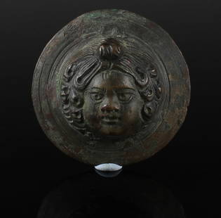 Roman tondo / roundel with Eros head: ITEM: Tondo / Roundel with Eros head MATERIAL: Bronze CULTURE: Roman PERIOD: 1st - 3rd Century A.D DIMENSIONS: 45 mm diameter CONDITION: Good condition PROVENANCE: Ex American private collection,