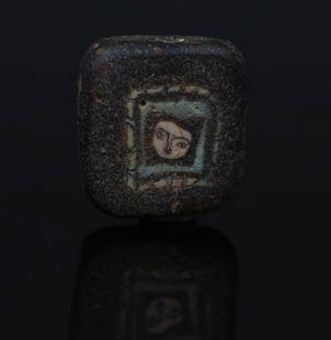 Romano-Egyptian face bead, probably Medusa: ITEM: Face bead, probably Medusa MATERIAL: Mosaic glass CULTURE: Romano-Egyptian PERIOD: 1st Century B.C - 1st Century A.D DIMENSIONS: 14 mm x 13 mm CONDITION: Good condition PROVENANCE: Ex Dutch