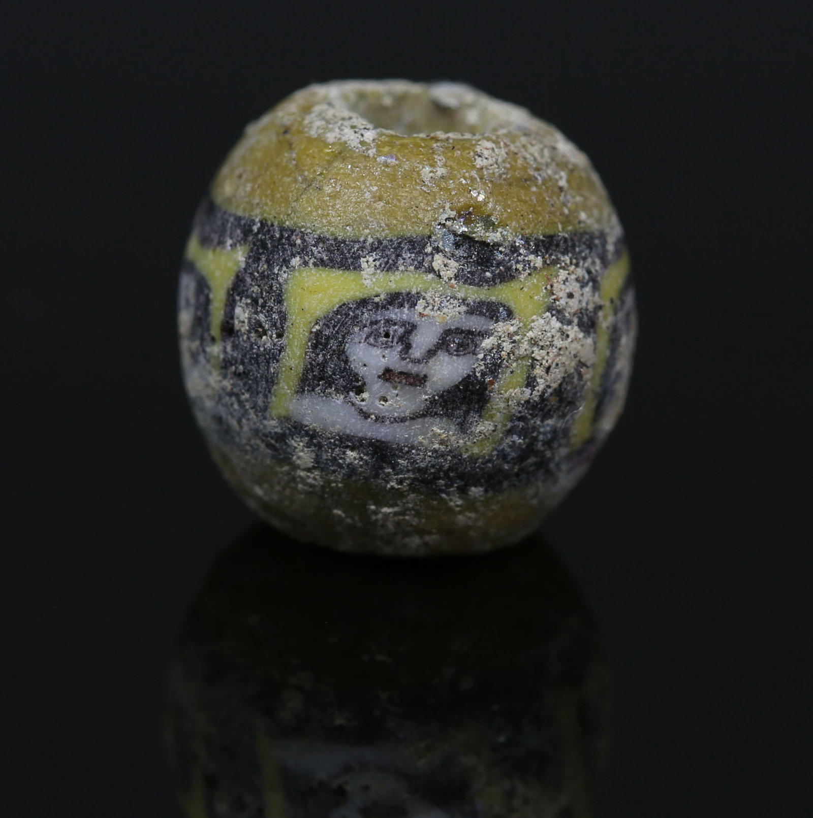 Romano-Egyptian face bead, probably Medusa: ITEM: Face bead, probably Medusa MATERIAL: Mosaic glass CULTURE: Romano-Egyptian PERIOD: 1st Century B.C - 1st Century A.D DIMENSIONS: 14 mm diameter CONDITION: Good condition PROVENANCE: