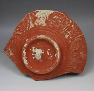 Roman bowl fragment with decoration and maker's mark: ITEM: Bowl fragment with decoration and maker's mark MATERIAL: Terra Sigillata CULTURE: Roman PERIOD: 1st - 2nd Century A.D DIMENSIONS: 90 mm x 195 mm CONDITION: Good condition, fragmentary