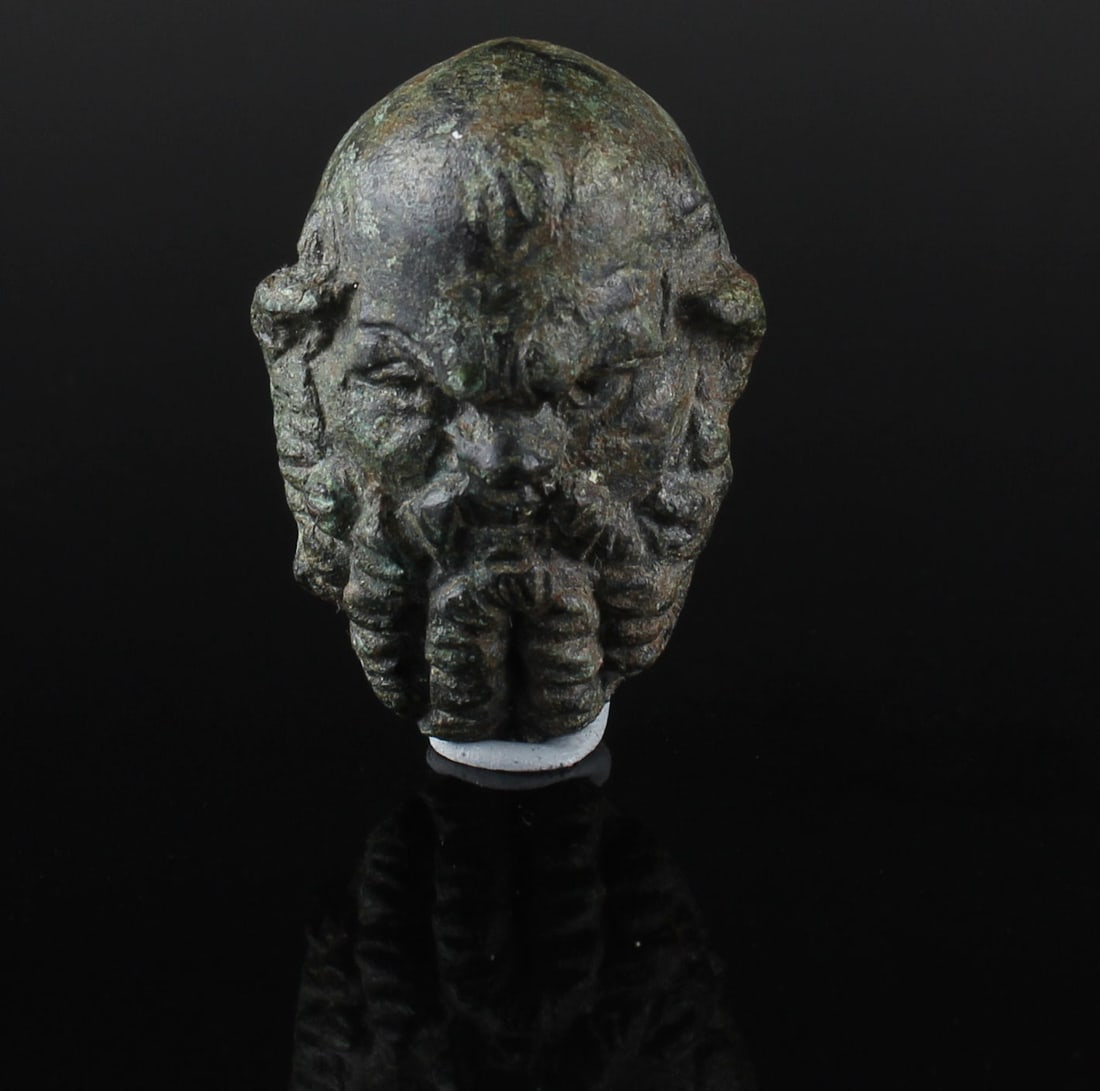 Roman Silenus head applique: ITEM: Silenus head applique MATERIAL: Bronze CULTURE: Roman PERIOD: 2nd - 3rd Century A.D DIMENSIONS: 40 mm x 28 mm CONDITION: Good condition PROVENANCE: Ex South German private colle