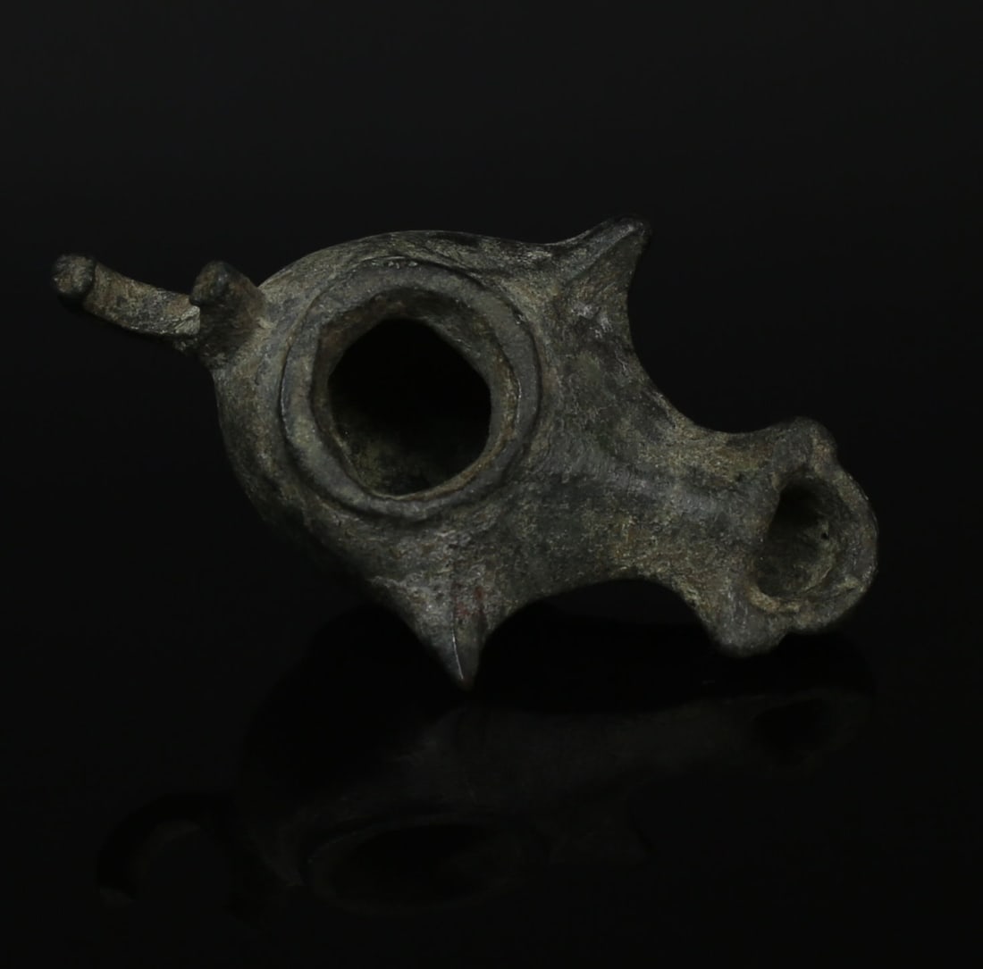 Roman oil lamp: ITEM: Oil lamp MATERIAL: Bronze CULTURE: Roman PERIOD: 1st - 2nd Century A.D DIMENSIONS: 18 mm x 34 mm x 55 mm CONDITION: Good condition PROVENANCE: Ex Dutch private collection, acqui