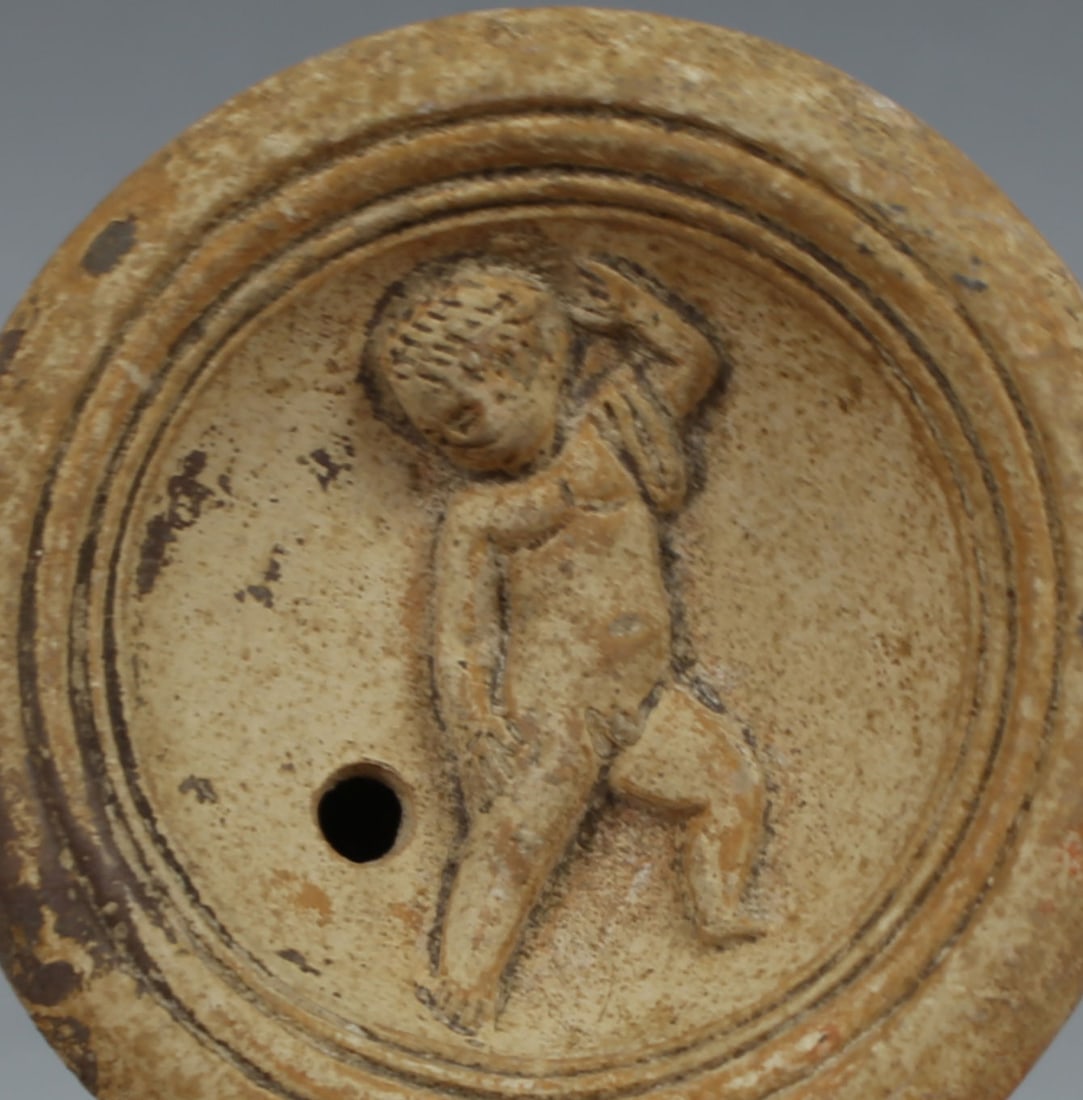 Roman oil lamp, Type Bussière B III 1: ITEM: Oil lamp, Type Bussière B III 1 MATERIAL: Pottery CULTURE: Roman PERIOD: 1st Century A.D DIMENSIONS: 28 mm x 75 mm x 103 mm CONDITION: Good condition PROVENANCE: Ex American pri