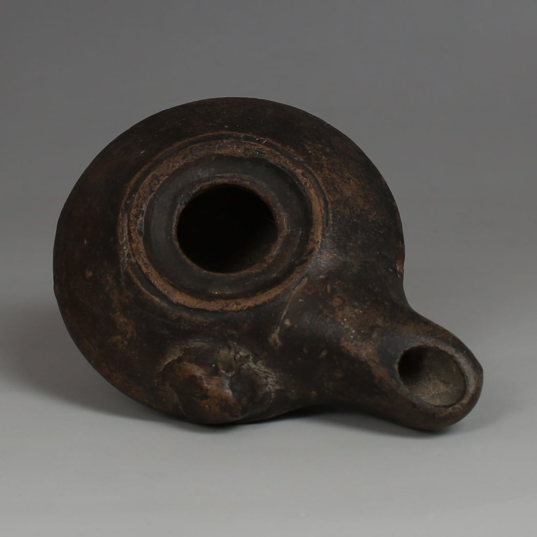 Greek oil lamp, Type Howland 28 A: ITEM: Oil lamp, Type Howland 28 A MATERIAL: Pottery CULTURE: Greek PERIOD: 4th - 3rd Century B.C DIMENSIONS: 34 mm x 68 mm x 91 mm CONDITION: Good condition PROVENANCE: Ex French priv