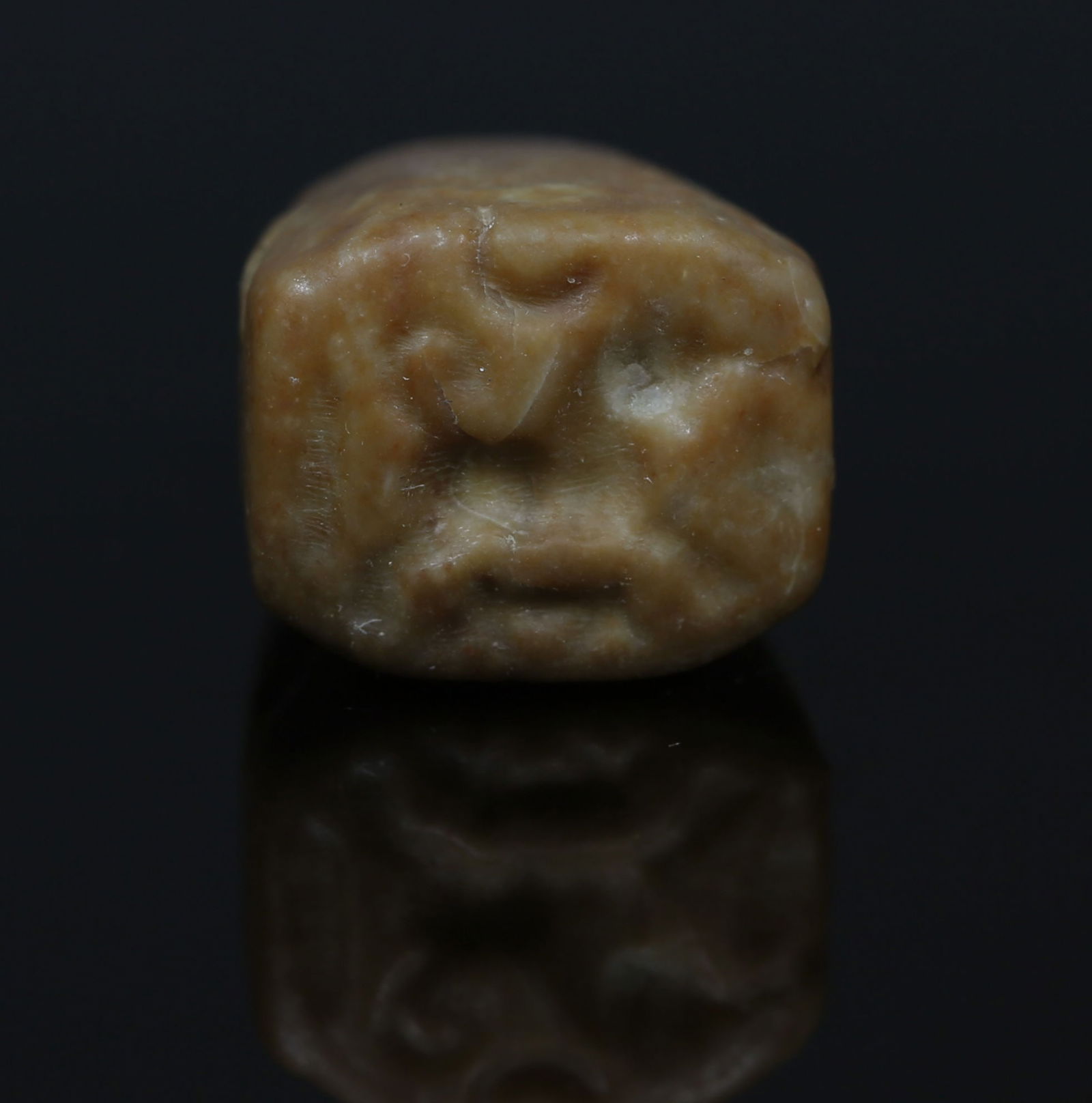 Iron Age, Ammonite stamp seal depicting prancing bull with young, likely a depicting of Baal-Milkom,: ITEM: Stamp seal depicting a prancing bull with young. A lunar crescent and floral motifs in the exergue. Likely a depiction of Baal-Milkom. MATERIAL: Stone CULTURE: Iron Age, Ammonite PERIOD: 7th Cen