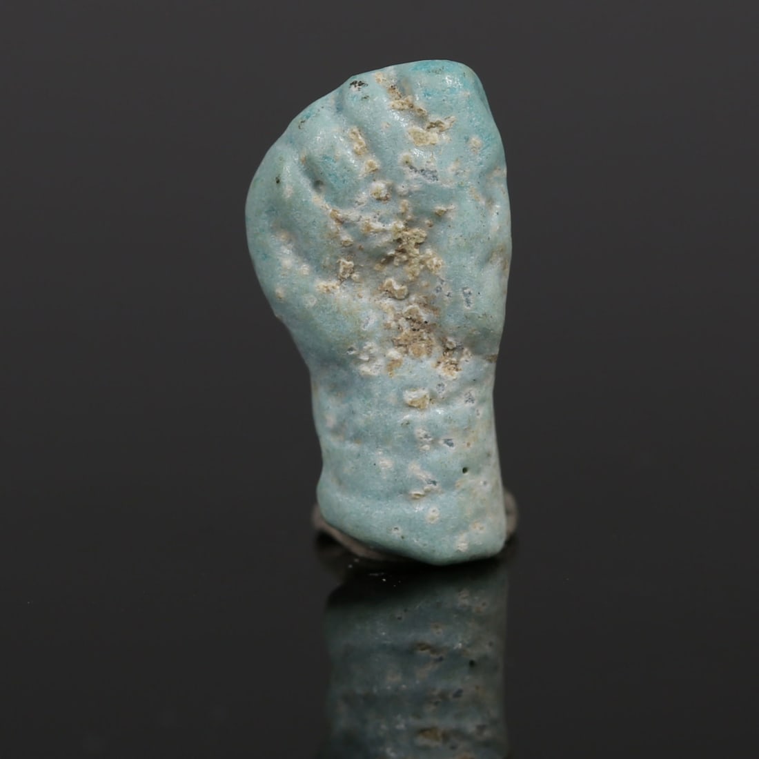 Romano-Egyptian votive 'Manu fica' amulet: ITEM: Votive 'Manu fica' amulet MATERIAL: Faience CULTURE: Roman PERIOD: 1st - 3rd Century A.D DIMENSIONS: 19 mm x 9 mm CONDITION: Good condition PROVENANCE: Ex Austrian private colle