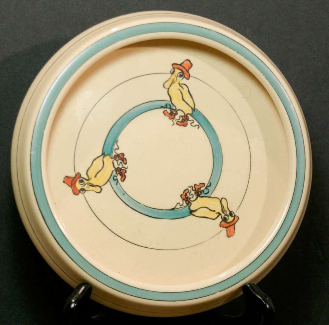 antique Roseville pottery deep plate: antique marked RV on the bottom as shown baby or kids' rimmed bowl or plate with 3 yellow ducks wearing a hat and matching orange shoes design 7 1/2" in diameter