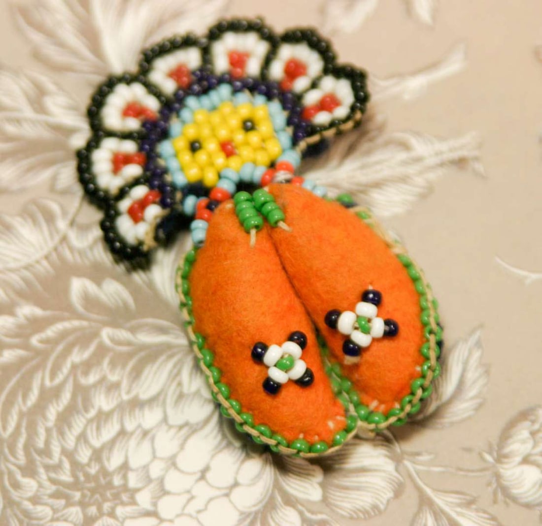 vintage estate jewelry: Native American pin brooch: vintage felted wool and hand stitched seed or trade beads Native American Indian miniature shoes or moccasins with a face design, pin on the back, vibrant bright colors of orange, gr