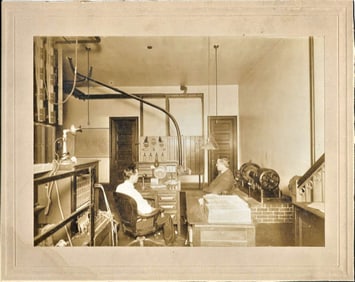 antique mounted photograph of 2 men in electric control room