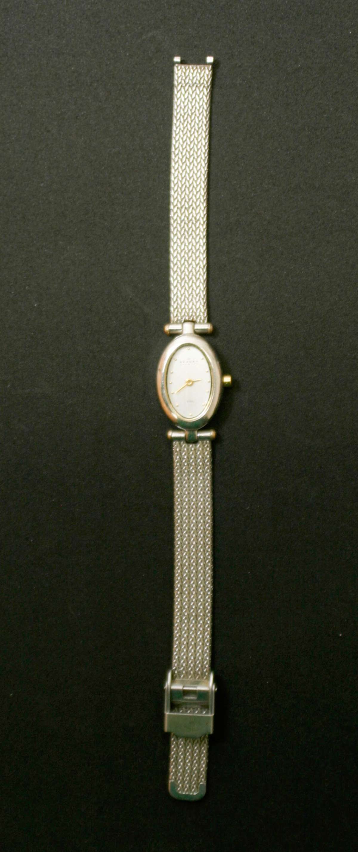 vintage estate jewelry: Skagen wrist watch: ladies' model silver toned Skagen watch with a stainless steel metal band, marked on the back Denmark and serial number as shown