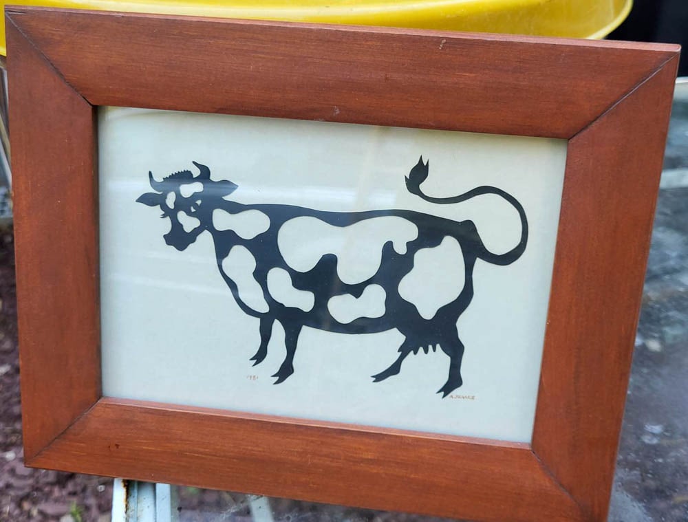 vintage Folk Art scherenschnitte of a cow: small artwork by artist Arlene France who lives in Lititz Pennsylvania and dated 1981, framed black paper cutout of a white spotted cow