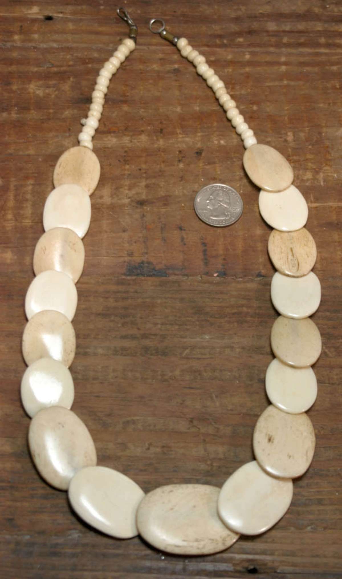 vintage estate jewelry: bone necklace: oval flattened carved bone discs with rounded beads and simple hook closure, see close-up photos for bone detail roughly 22" long