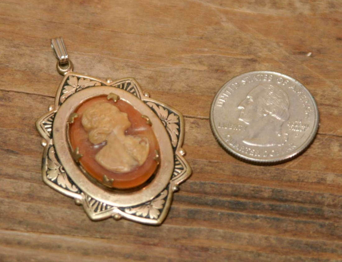 antique estate jewelry: Cameo pendant: antique unmarked but likely gold filled and black enameled floral design pendant with Cameo with lady's head or bust looking to the right