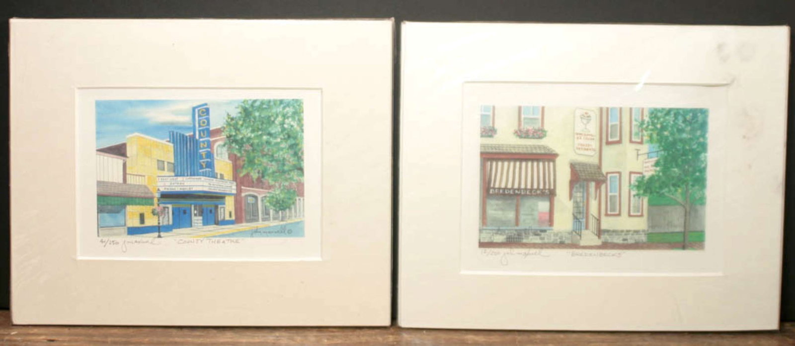 vintage pair of prints of retro buildings: artist signed John Maxwell, numbered for an edition of 250 and one named County Theatre and the other Bredenbecks, ready to framematte about 10 1/8" wide by 8 1/8" high each piec