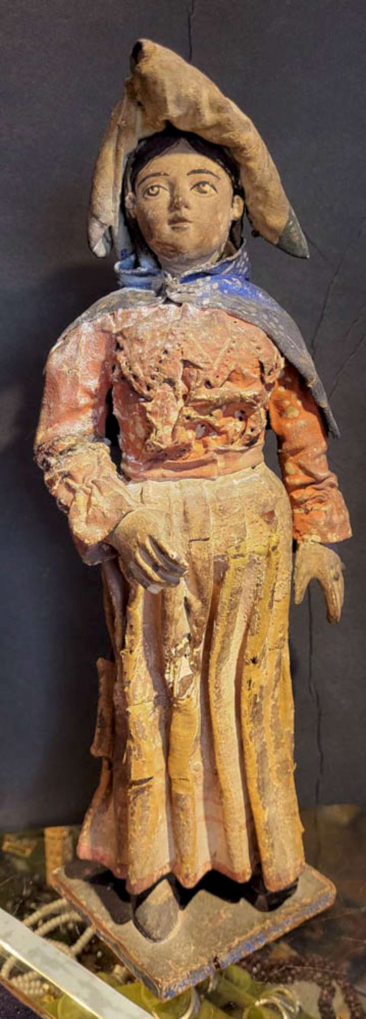 antique Folk Art figural statue of a woman: one customer suggested this might be an organ grinder statue, but it's more likely an 1800's carved wooden sculpture of a Mexican or Latina woman with remnants of actual fabric clothin