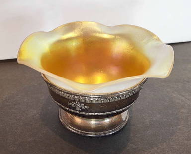 antique Steuben Aurene in Sterling silver base: unmarked Steuben Aurene iridescent gold scalloped edge dish in a fitted marked Sterling silver footed base with edge rim designInfo from online search: "Steuben was founded in 1903 by renowned En