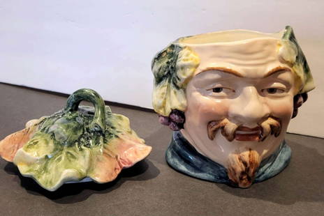 antique pottery figural tobacco jar: antique figural porcelain or Majolica chew or tobacco pot or humidor with lid&comma; shaped like a man with a goatee (Bacchus) with leaf headdress with grapes and marked underneath as shown with numbe