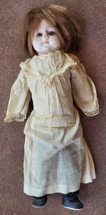 antique composite head girl doll: blue eyed vintage or antique composite head doll with overpainted face and wearing an antique linen dress&comma; socks and shoes&comma; unmarked