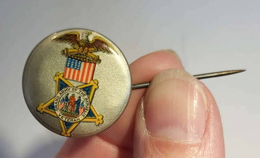 antique post Civil War button or pin: antique Grand Army of the Republic (GAR) button or lapel pin for the fraternal organization of Union Civil War veterans&comma; depicting an Eagle atop two cannons and a patriotic American flaginfo fro