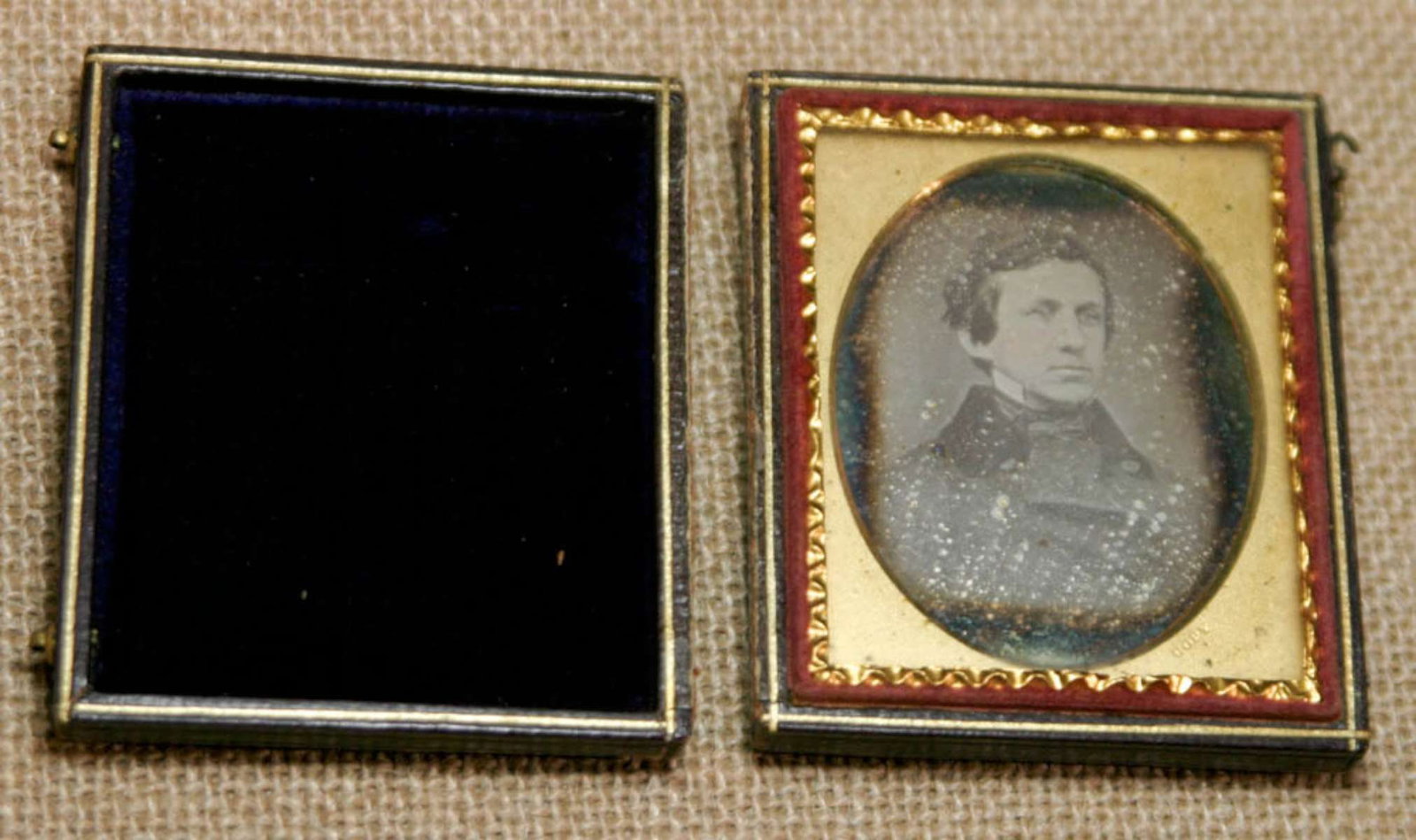 antique Daguerreotype photograph: or Ambrotype (see below) of a close-up portrait of a man wearing what looks to be a military jacket or coat and with hand tinted cheekscase about 2 1/2" by 2 7/8"Info from online search: &qu