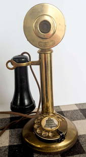 antique brass Western Electric candlestick telephone: patent dated 1910 and made in brass&comma; heavy antique phone with (Bakelite?) black earpieceInfo from online search: &quot;Produced by the Western Electric Company&comma; a subsidiary of the America