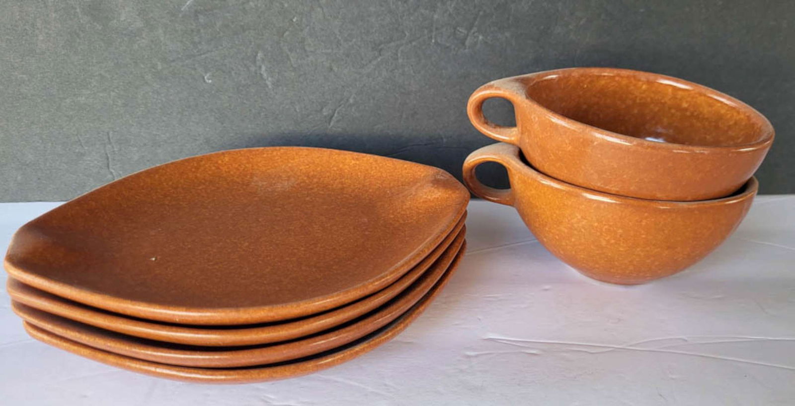 vintage Roseville Raymor tea cups and saucers: vintage ca. 1950's Ben Seibel designed tea or coffee set consisting of 4 saucers and 2 handled cups in a mottled yellow and brown color and marked as shown