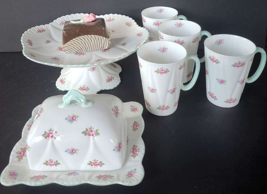 vintage English Shelley Rosebud serving set: English bone chine tea or scone serving set, marked as shown Shelley England and consisting of 4 handled mugs, a lidded (cheese?) serving dish and a footed scone or pastry platter, a