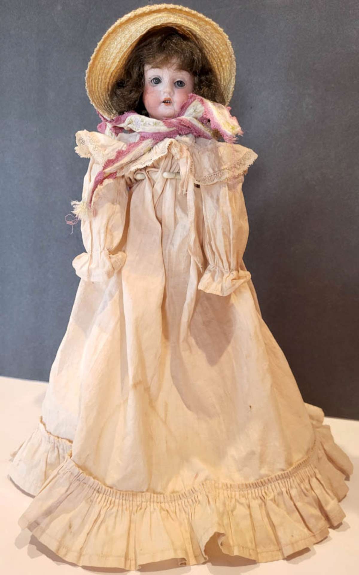 antique German porcelain head girl doll: unusual posable composite body with "butt" for easier sitting, small bisque or porcelain head doll marked Germany as shown and with open mouth and rounded-off teeth showing, blue