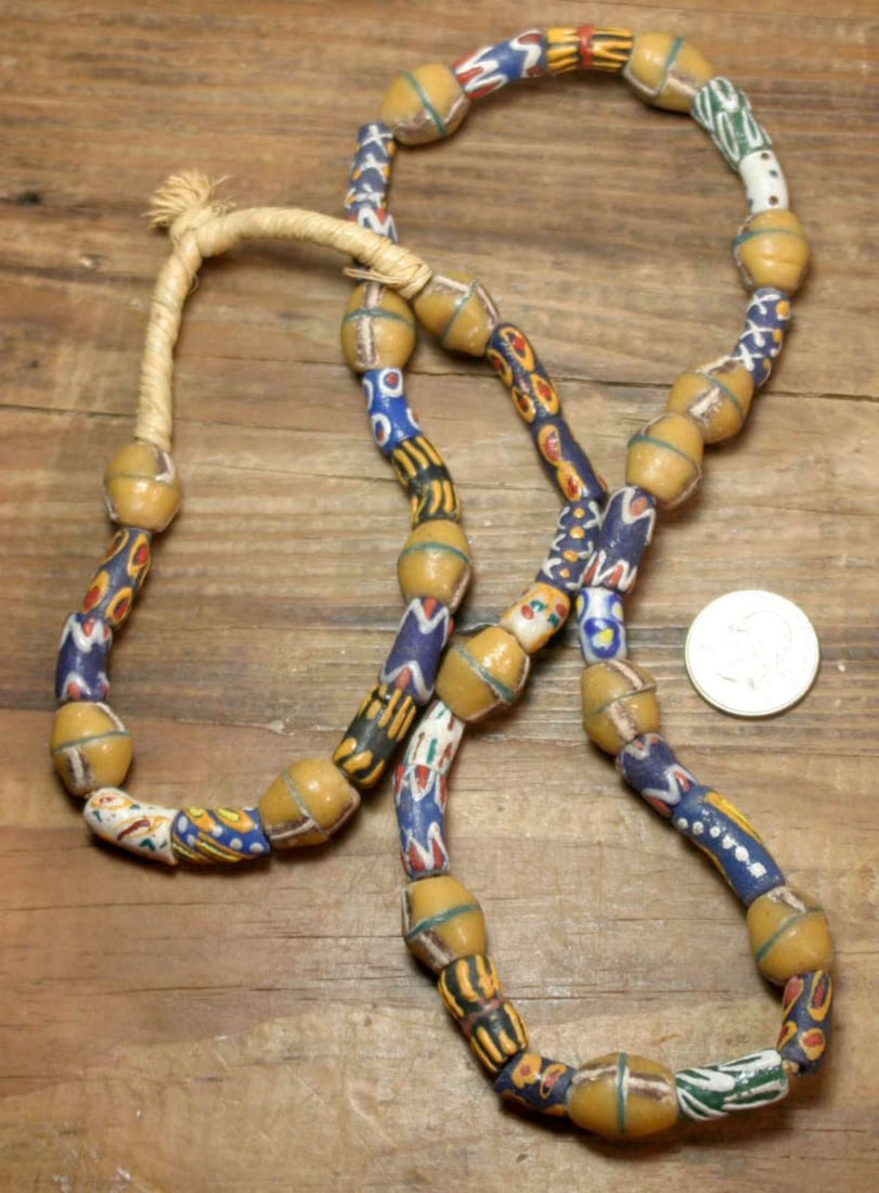 vintage estate jewelry: African necklace: very long and heavy vintage or antique African tribal trade bead necklace with Venetian pottery beads in vibrant colors of blue, mustard yellow and green and hand knotted with rope ends