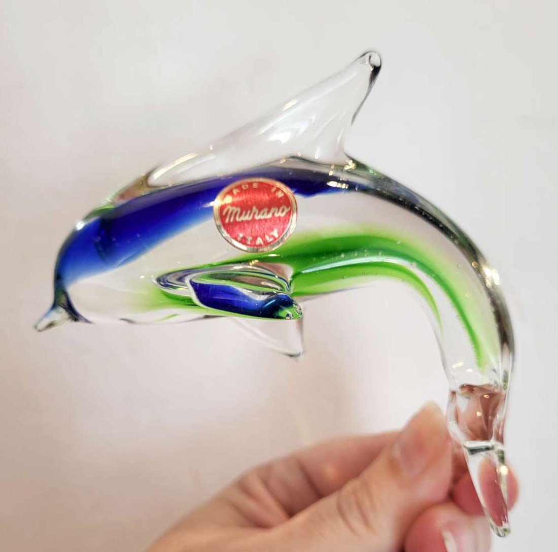 vintage figural glass paperweight by Murano: vintage clear and green and blue swirl paperweight shaped like a jumping Dolphin and marked with the original paper label Murano Made in Italy as shown