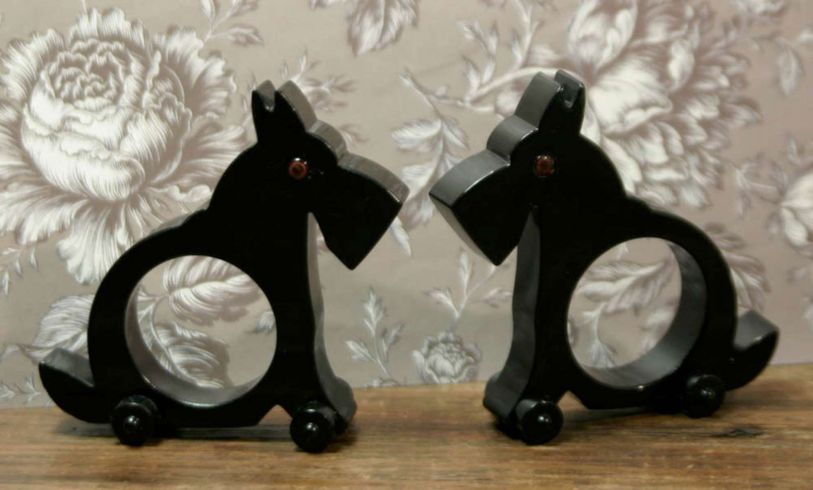 Art Deco Scottie dog napkin rings: matching pair of vintage Art Deco style black wheeled napkin rings with red or brown glass eyes, possibly French (sold on 1stDibs for 100 dollars each)