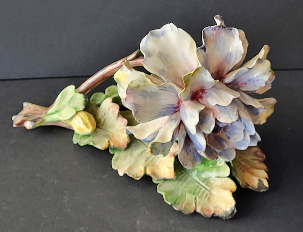 vintage Italian porcelain floral sculpture: vintage porcelain statue shaped like a yellow and pinkish blue Capodimonte style flower, marked N ICA Italy as shownabout 8" long by roughly 6" wide by 5" high