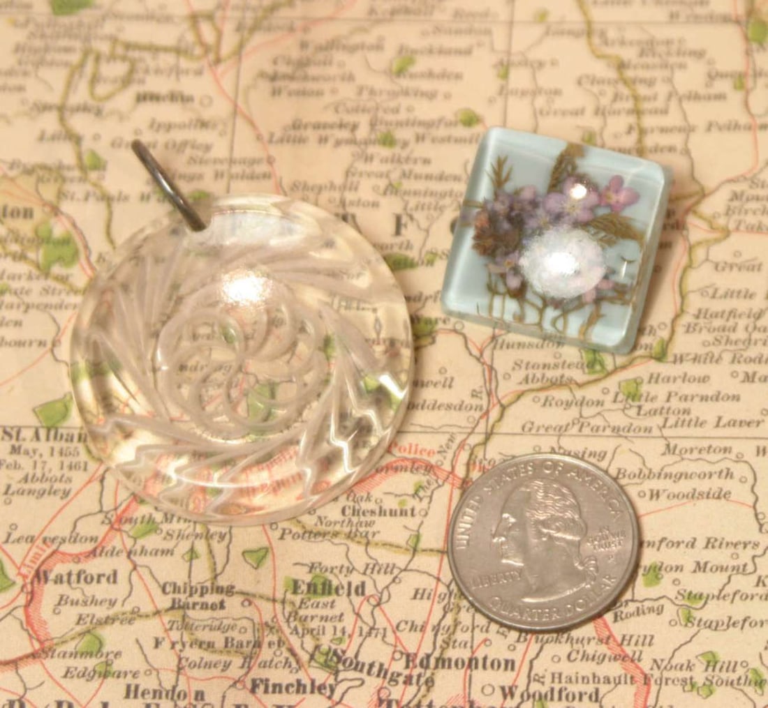vintage estate jewelry: Lucite pieces: set or lot of two vintage Art Deco period Lucite items, first a bubble pin brooch with floral design, second a clear carved donut shaped round necklace charm or pendant with abstract flowe