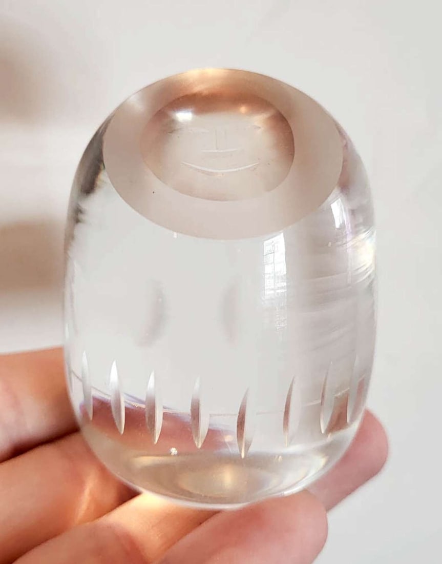 vintage figural Inuit glass paperweight: vintage clear glass paperweight shaped like an Eskimo or Inuit person with a happy smile on its face, unmarked