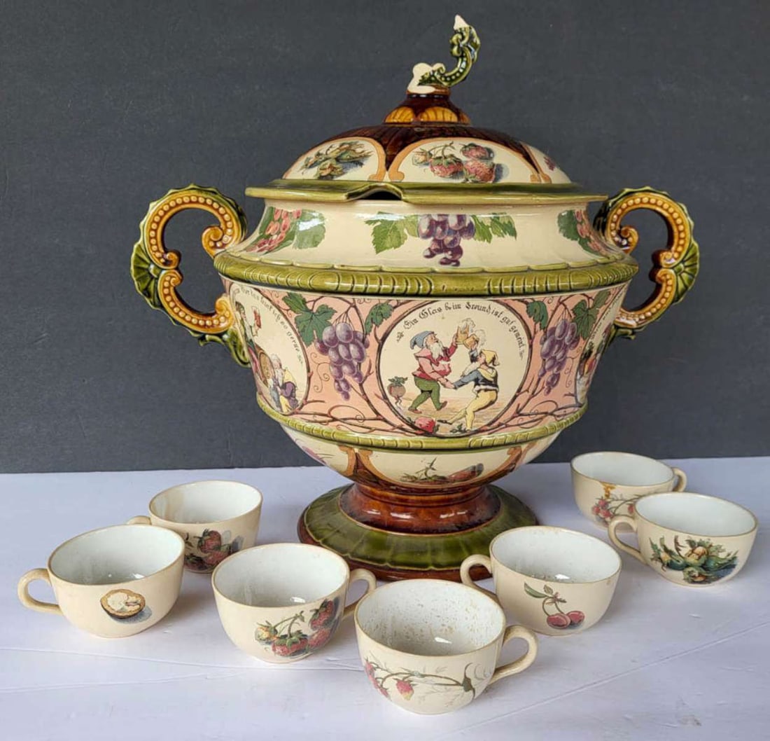 antique Mettlach pottery punch bowl and cups: late 1800's pottery Villeroy and Boch large double handled and footed soup tureen or punch bowl or Gluhwein mulled wine pot with 7 handled cups, all with elaborate designs, bowl with