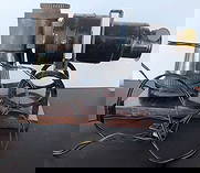 antique Magic Lantern slide projector: ca. late 1800's antique tin and brass photograph viewer and projector, works on a light bulb (see close-ups) and is mounted on a wooden board and with maker's name stamped as shownInfo