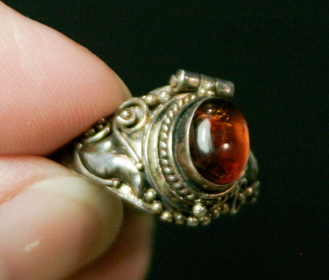 vintage estate jewelry: silver poison ring: unusual poison ring with lid to hide snuff or other substances, marked as shown 925 for Sterling silver and M412 or M912 (?) and with elaborate design work on the band with swirls and center cab