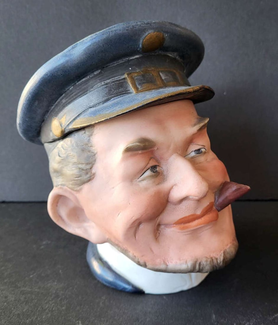 antique pottery figural tobacco jar: antique tobacco pot with lid, shaped like a ship's captain (or train conductor??) smoking a cigar, unmarked but with previous owner's receipt from 1995 for 120 dollars