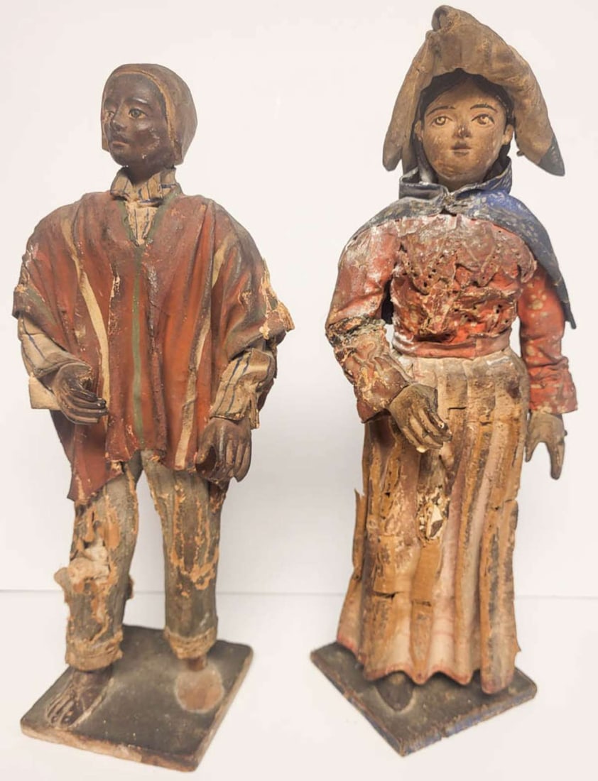 PAIR antique creche figures Nativity scene: set or lot of two antique composite materials (clay, wood, fabric and paper mache) figural religious or Christmas statues, first of a young man or boy selling or peddling wares (a fi