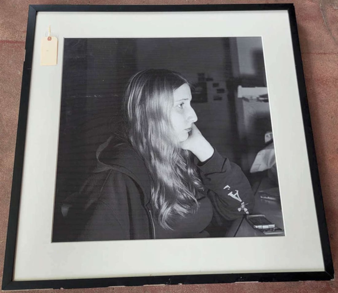 large original Chris Heard b/w photograph: large framed and matted black and white portrait photograph or toned gelatin silver print depicting a young woman listening to someone with a cell phone by her elbow and titled TAPT/ure number 3 and d
