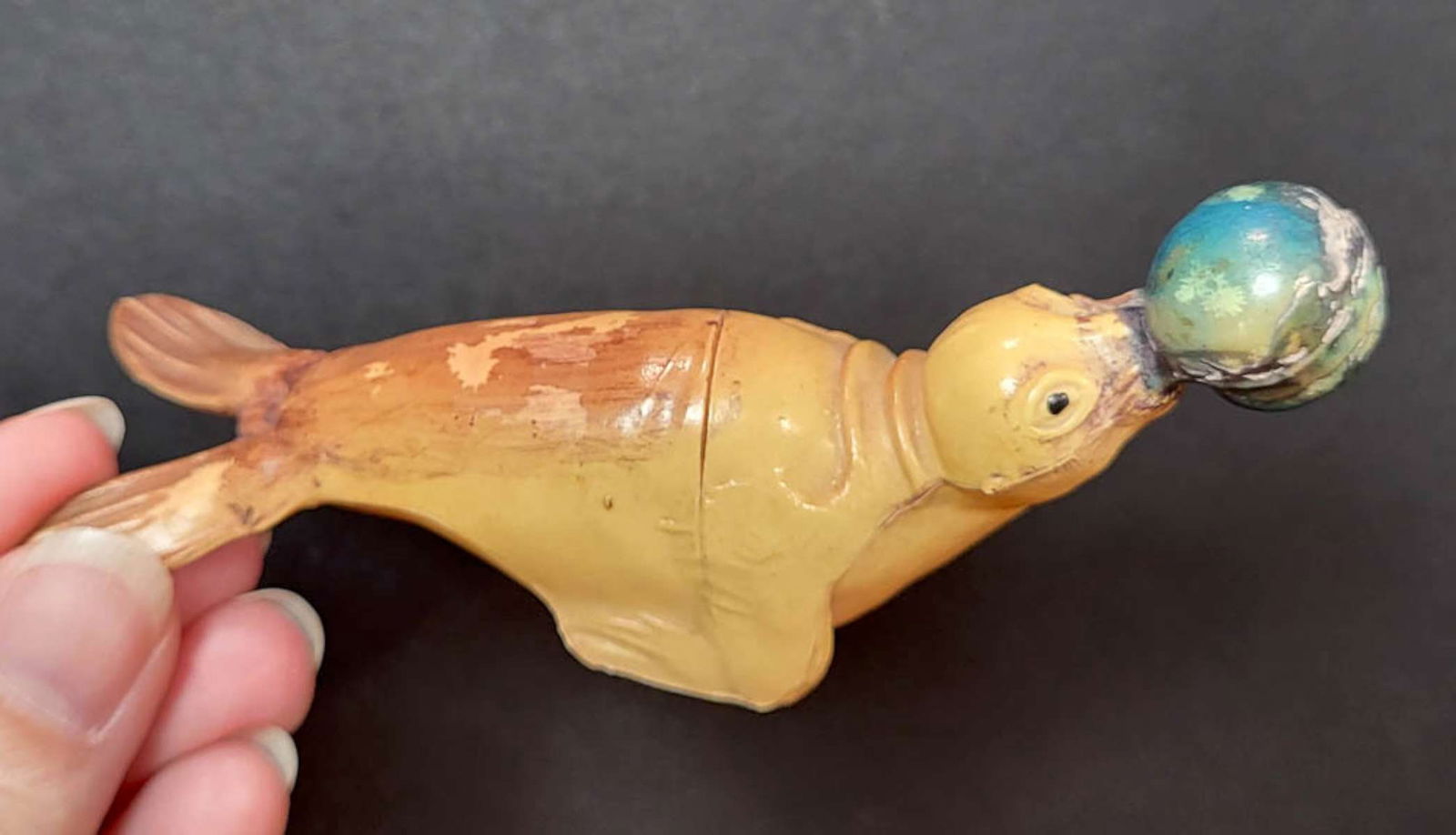 antique animal shaped celluloid toy: vintage or antique seal with a blue ball on its nose celluloid toy, small illegible (VOC?) maker's mark made in USA