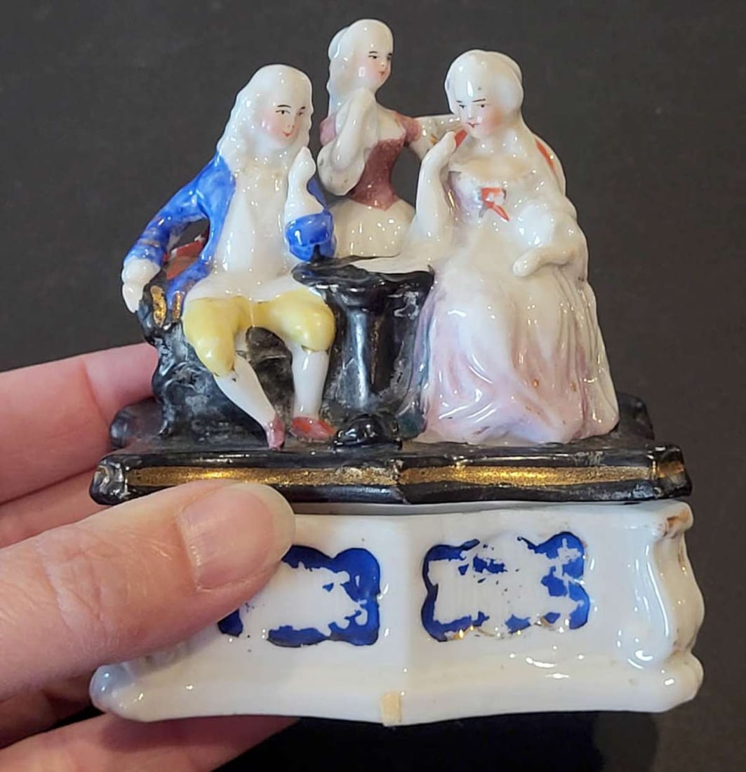 antique porcelain fairing box with family scene: antique late 1800's white porcelain lidded fairing (trinket, jewelry/ring or match) box with lid with family scene of a gentleman, lady and girl child in Renaissance clothing, b